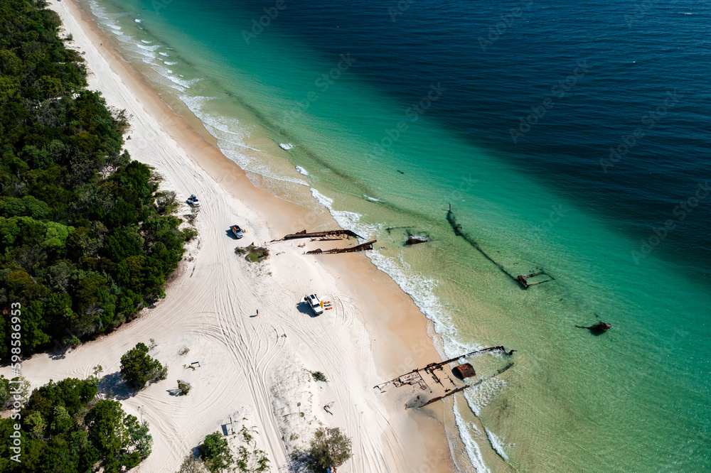 Wall mural shipwrecks and offroad vehicles on pristine beach at moreton island