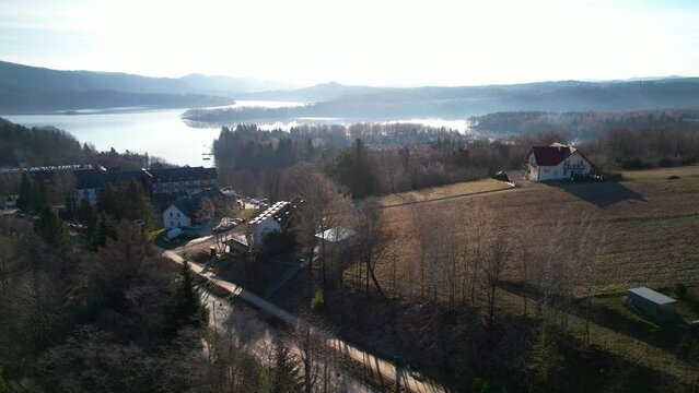 Polanczyk village and Bieszczady Mountains  in Lesko County, on the banks of Solina Lake in Poland countryside- aerial dolly on sunset