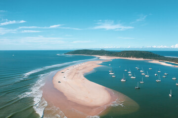 Boats and 4wd vehicles on the beach at Double Island Point