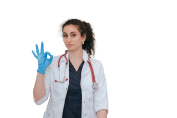 Brunette female doctor makes ok gesture looks at camera wearing medical clothes standing against transparent background. Satisfied nurse after successful day.