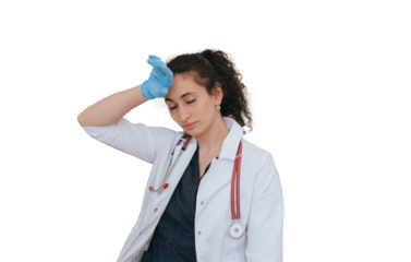 Exhausted female doctor in medical clothes touches temple eyes closed, tired after hard work. Young nurse tired stands against transparent background with hands in  medical gloves.