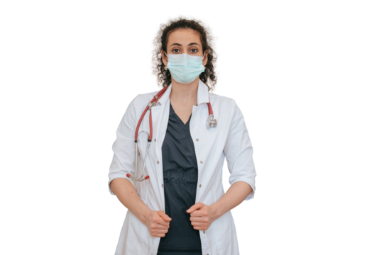 Confident female nurse in medical clothes wearing face mask looks at camera standing against transparent background. Medicine, treatment concept. American doctor waits for patient.