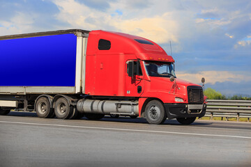 American Truck Drives on a Country Road