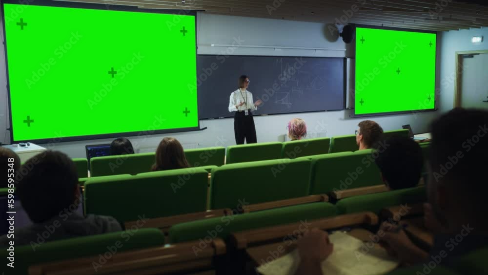 Fototapete young university professor giving a lecture, pointing on a green screen mock up display. group of sm