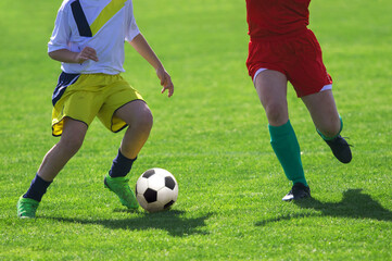 Plakat Soccer Players in a Duel on Grass Running After Soccer ball