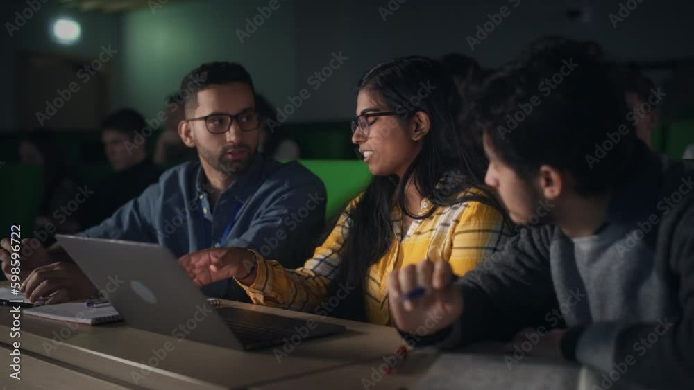 Poster group of multiethnic enthusiastic students collaborate in university classroom, compare research pro