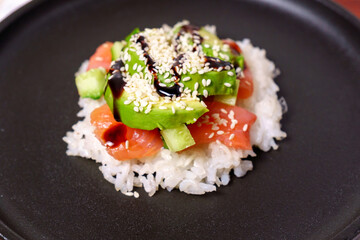 Sushi waffles are crispy rice cooked in a waffle iron, with salmon crunchy cucumber, and avocado.