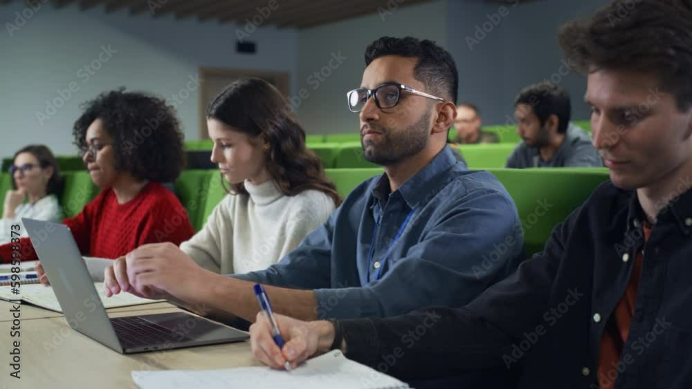 Poster Smart Handsome Male Student Studying in University with Diverse Multiethnic Classmates. Young Man is Using a Laptop Computer to Summarize the Lecture, Study at Home and Pass the Exams