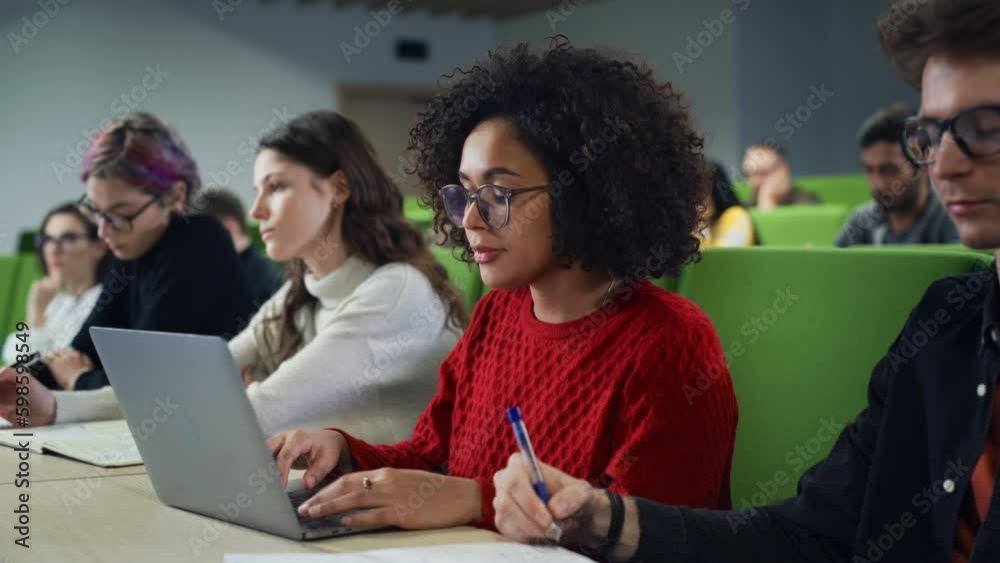 Poster portrait of an empowered african female student studying in university with diverse multiethnic clas