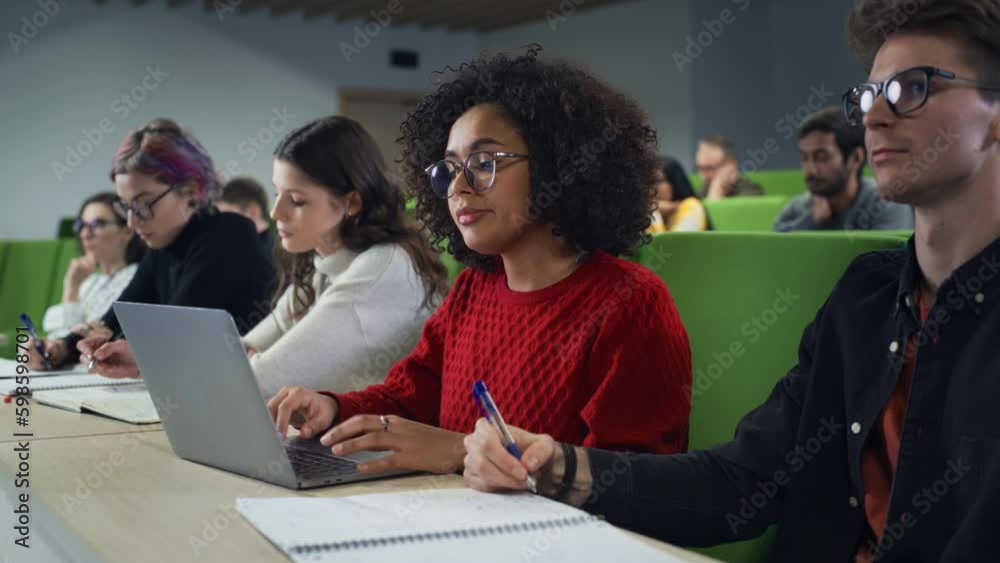 Leinwandbilder beautiful multiethnic african female student studying in university with diverse classmates. young b