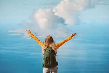 Traveler raised hands hiking in mountains woman with backpack outdoor travel lifestyle active vacations in Greece girl enjoying island and sea view