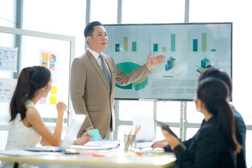 ฺฺBusiness 
 Successful businessman presenting work plan analytical report to colleagues in modern office