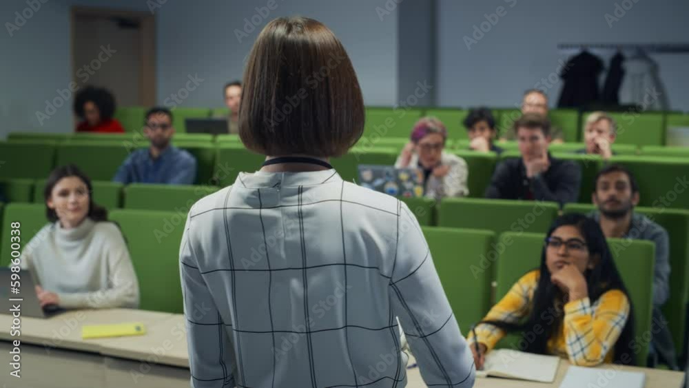 Poster excited female teacher giving lecture to a diverse multiethnic group of students in a modern college