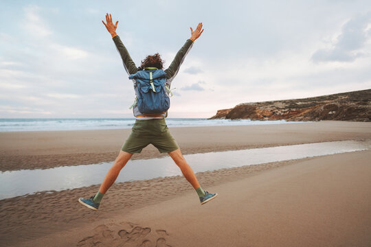 Man Jumping On The Beach Travel With Backpack Healthy Lifestyle Emotional Success Concept Adventure Active Vacations Outdoor