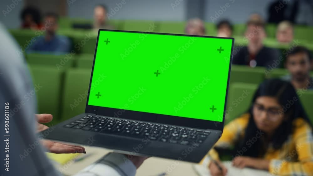 Leinwandbilder Close Up of an University Professor Using a Laptop Computer with a Green Screen Mock Up Display. Female Teacher Giving a Lecture to a Class of Talented Diverse Young Men and Women.