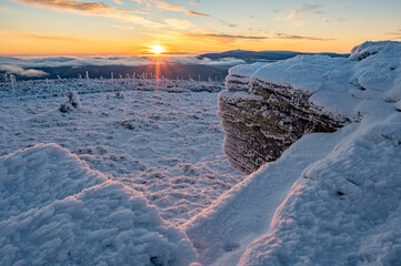 Wintermood sunrise in a mountains with frozen stones and spruce trees with inversion in Jeseniky...