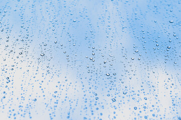 close up of water droplets on clear window. rainy day concept.