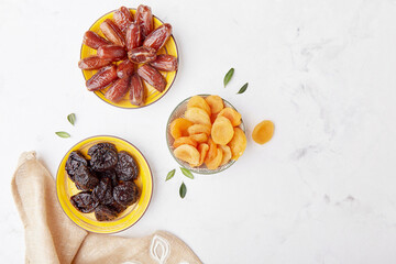 Top view of Ramadan food. Healthydiet food - prunes, dried apricots, dates top view, copy space
