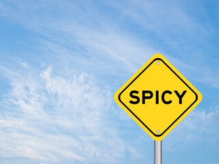 Naklejka premium Yellow transportation sign with word spicy on blue color sky background