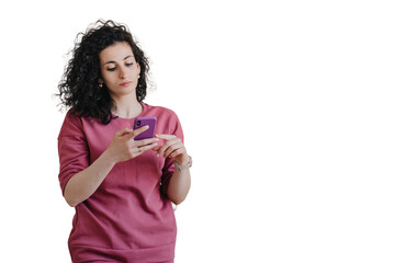 Upset young curly woman in violet sweater holds phone looks at screen with frustrated face expression against transparent background. People emotions. Troubles, fatigue, exhaustion. Disappointed woman