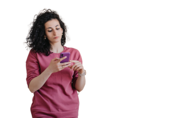 Upset young curly woman in violet sweater holds phone looks at screen with frustrated face expression against transparent background. People emotions. Troubles, fatigue, exhaustion. Disappointed woman