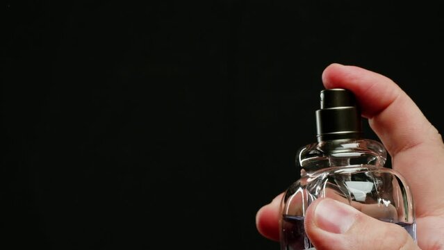 Young man applying perfume to skin in the dark, close up of spraying deodorant luxury perfume. Generative AI