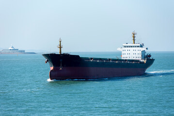 Cargo ship sailing near Chinese sea coast in the vicinity of Macau and Hong Kong. 