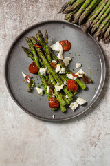 Grilled asparagus with goat cheese and tomatoes