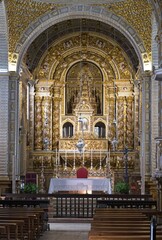 Fototapeta premium Nazare, Portugal - March 28, 2023: The Sanctuary of Nazare (Santuario de Nossa Senhora da Nazare) is located on the hilltop called O Sitio. 14th century. Sunny spring day. Selective focus