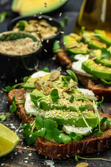 Naklejka na ściany i meble avocado toasts with rye bread, Delicious breakfast or snack, Clean eating, dieting, vegan food concept. top view