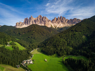 panoramic view of the dolomites in val di funes, the Odle with the village of Santa Maddalena below, Italy