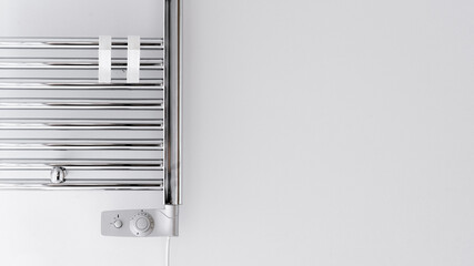 heated towel rail with thermostat in domestic bathroom