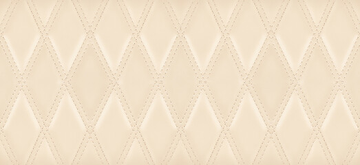 Close-up texture the genuine leather with beige rhombic stitching.
