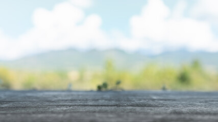 Empty, no people. Focus soft spot on the wooden table. Abstract natural cloud blue sky and mountain background. For use. The place for use product.