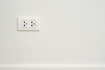 Electrical power socket plug outlet on concrete white wall.