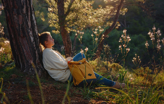 Travel and active lifestyle concept. Happy smiling woman hiking in mountains , Fethie, Turkey. Young female hiker smiling and have breack, sport and trekking in autumn or spring nature.