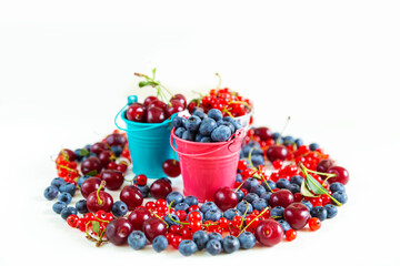 Mix of fresh berries in small buckets.