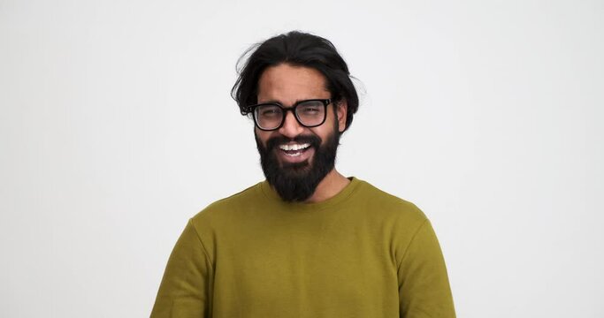 Portrait of cheerful handsome young man with beard laughing ecstatically and gesturing while looking at camera over isolated white background Generative AI