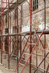 Scaffolding structure on construction site, renovation of an old industrial building