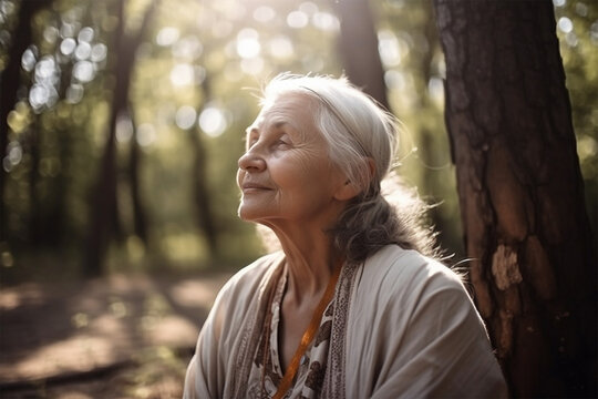 gray-haired woman meditating in the park in the shade of the foliage of trees .grandparents parents day. health and family concept. Generative AI  Generative AI