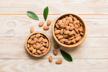 Fresh healthy Almond in bowl on colored table background. Top view