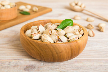 Fototapeta na wymiar Fresh healthy Pistachios in bowl on colored table background. Top view Healthy eating concept. Super foods