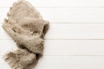 Old burlap fabric napkin, sackcloth on table background. top view with copy space