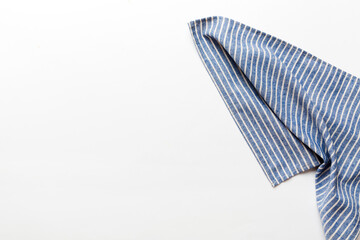 top view with blue kitchen napkin isolated on table background. Folded cloth for mockup with copy...