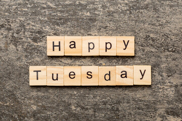 Happy Tuesday word written on wood block. Happy Tuesday text on cement table for your desing, concept