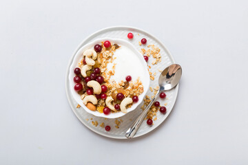 Healthy breakfast food with granola, yogurt, fruits and nuts. Dessert parfait with dried fruits for breakfast