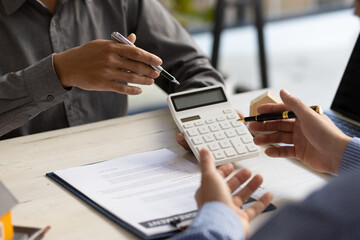 Real estate agent discuss about the terms of the home purchase agreement and asked the customer to sign the documents to make the contract legally, Home sales, lease, mortgage and home insurance.