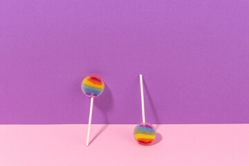  Rainbow lollipop lending front view on a purple and pink background