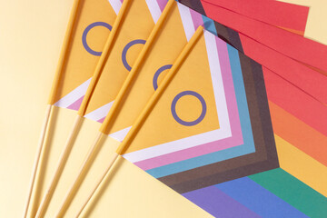 Lgtbiq+ flags fanned out close up banner on light yellow background