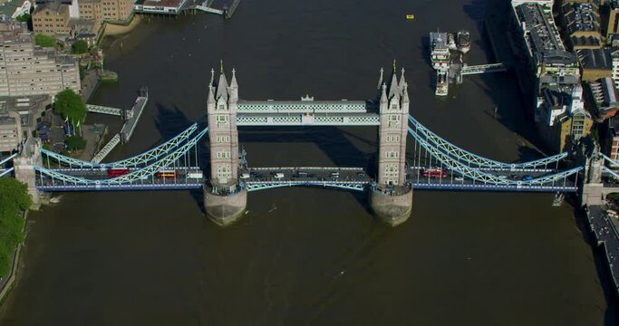 Aerial view of the Tower Bridge over River Thames an iconic symbol of London. Commuters and traffic passing by.